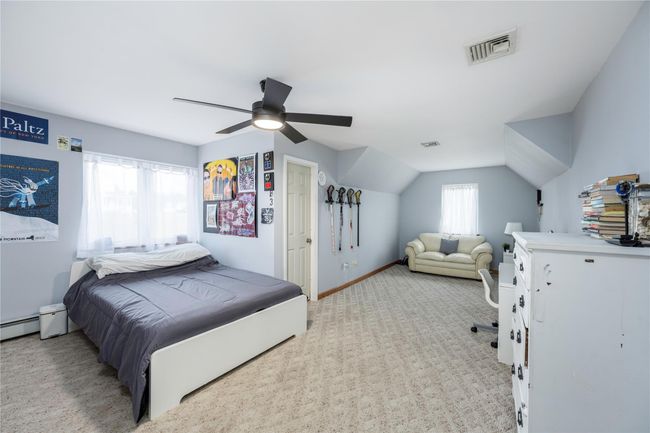 Bedroom with light colored carpet and ceiling fan | Image 23