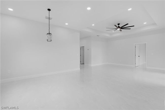 Spare room with ceiling fan and a raised ceiling | Image 2