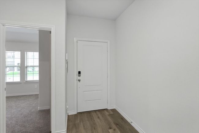 Foyer entrance featuring baseboards and dark wood-type flooring | Image 5