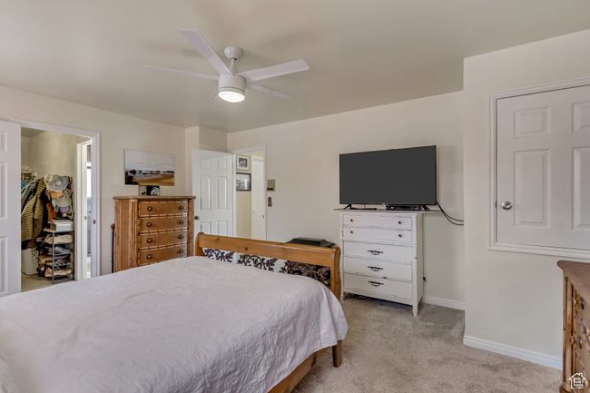 Bedroom with baseboards, light colored carpet, and ceiling fan | Image 26