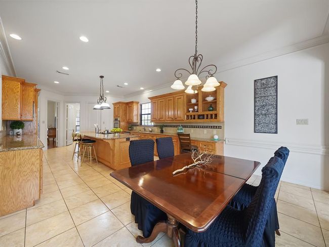 Cozy breakfast nook with seamless kitchen access. | Image 32