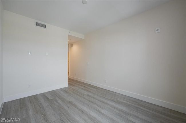 Empty room with baseboards, wood finished floors, and visible vents | Image 11
