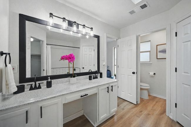 Full bath featuring vanity, toilet, and wood finished floors | Image 14