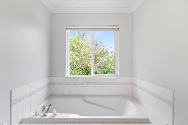 Full bath featuring a bath and crown molding | Image 16