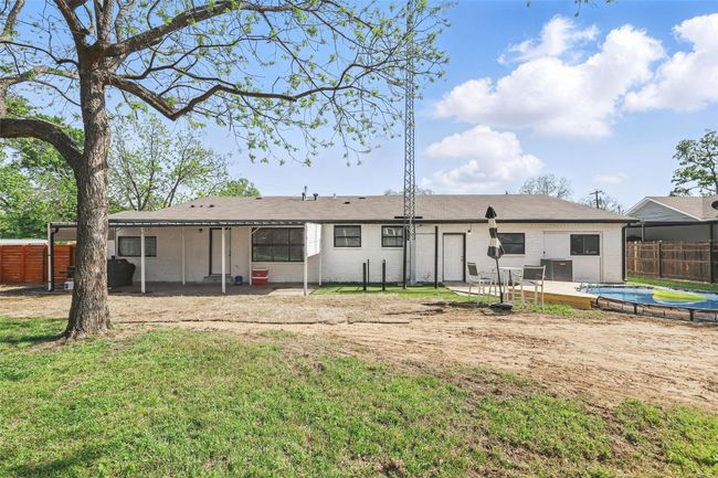 Rear view of property featuring a swimming pool and central AC | Image 40