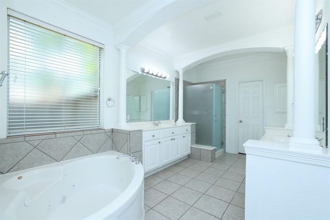 Large corner whirlpool tub oval tub.Recent shower door made of diffused glass for privacy. | Image 20