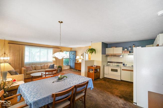 dining room featuring dark carpet and a chandelier | Image 15