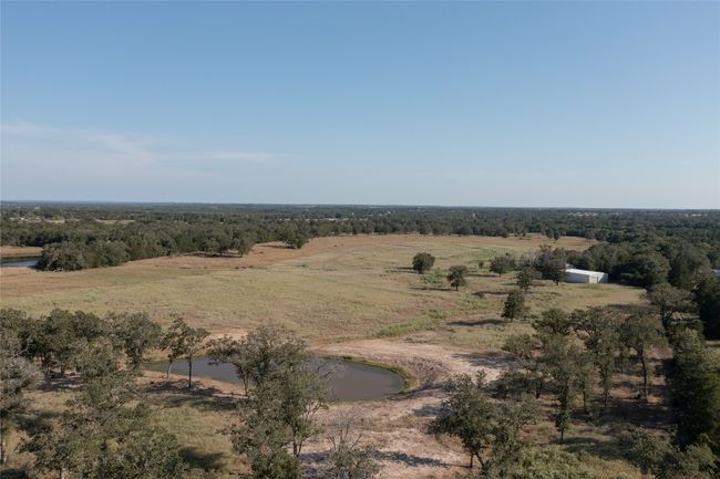 Aerial view of sparsely populated area with a large body of water | Image 12