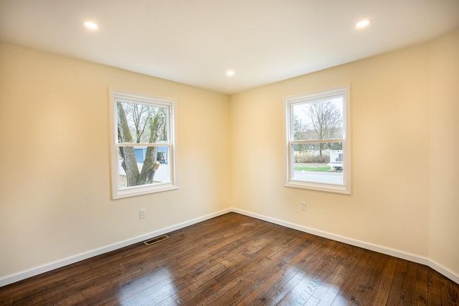 Unfurnished bedroom #1 with dark wood-style flooring, baseboards, and recessed lighting | Image 13