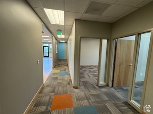 Hallway with carpet floors and a paneled ceiling | Image 32
