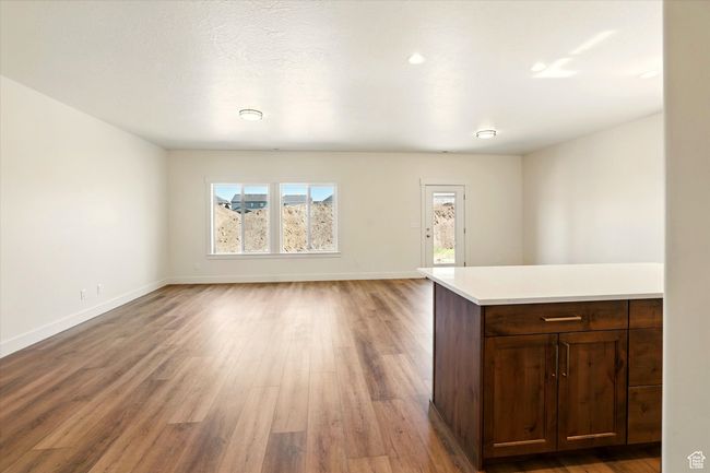 Unfurnished living room with light wood-type flooring and baseboards | Image 5