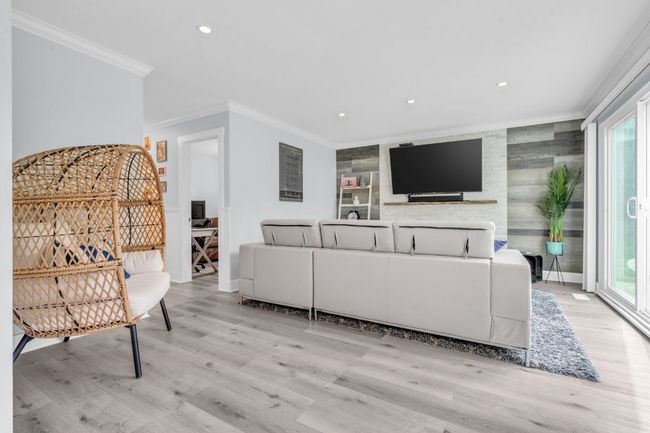 Living area with recessed lighting, baseboards, light wood finished floors, and ornamental molding | Image 13