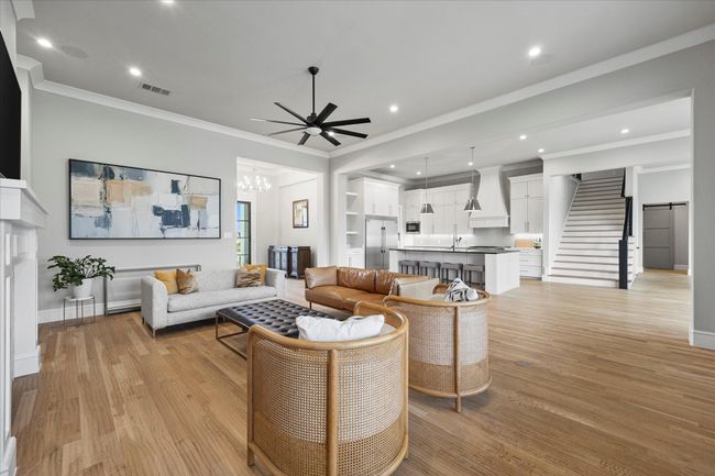 Open floor plan features kitchen opening onto family room and dining area | Image 7