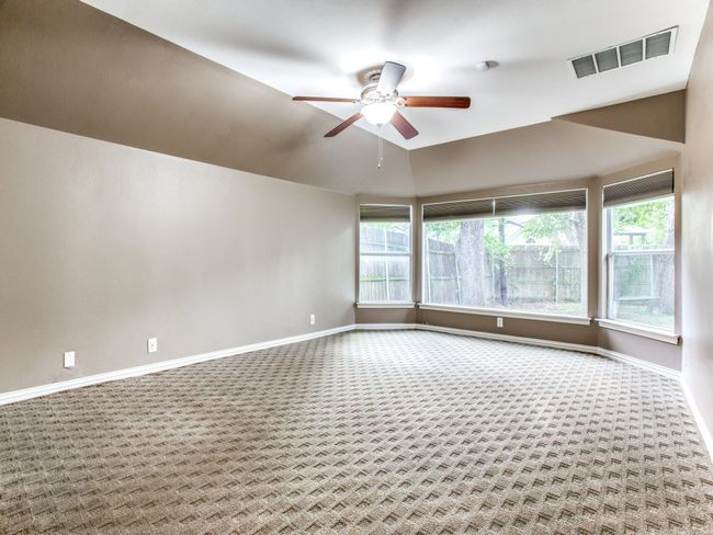 Unfurnished room with a ceiling fan, visible vents, carpet floors, and baseboards | Image 17