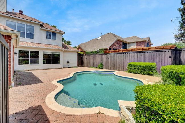 View of pool with a fenced in pool, a fenced backyard, and a patio | Image 5