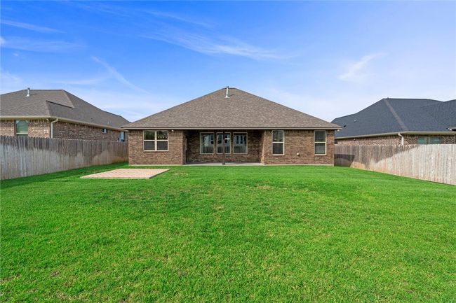 Rear view of house featuring brick siding, a shingled roof, and a patio area | Image 34