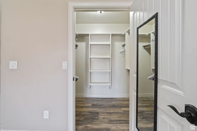 Walk in closet featuring wood finished floors | Image 12