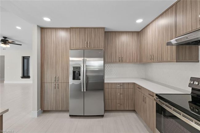 Kitchen with appliances with stainless steel finishes, ceiling fan, and light tile patterned floors | Image 8