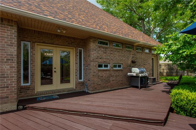 Deck featuring a grill, french doors, and fence | Image 26