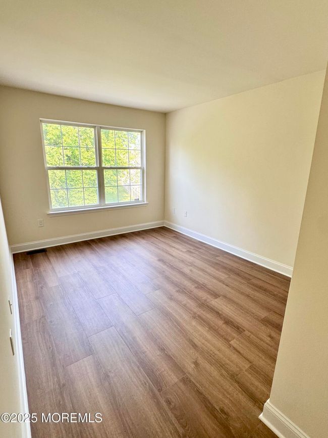 Second bedroom shown vacant with luxury plank waterproof plank flooring | Image 25