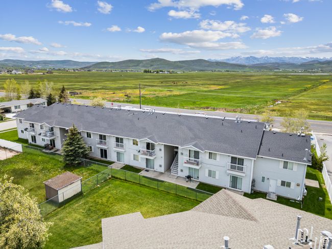 Aerial view of sparsely populated area featuring a mountainous background | Image 34