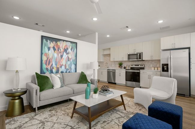 Living area with light wood finished floors and visible vents | Image 5