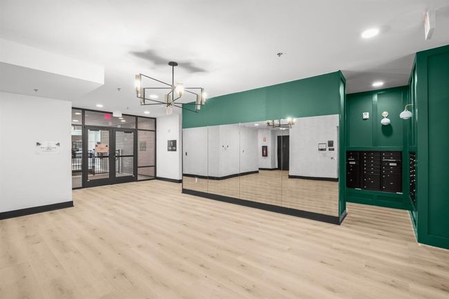Another Photo of Lobby area behind mirror is mail/package area. Doors lead to exterior Swimming pool | Image 21