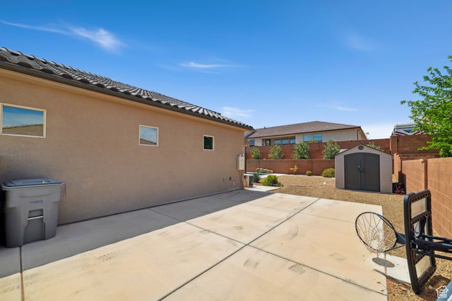 View of patio with a fenced backyard, an outbuilding, and a shed | Image 36
