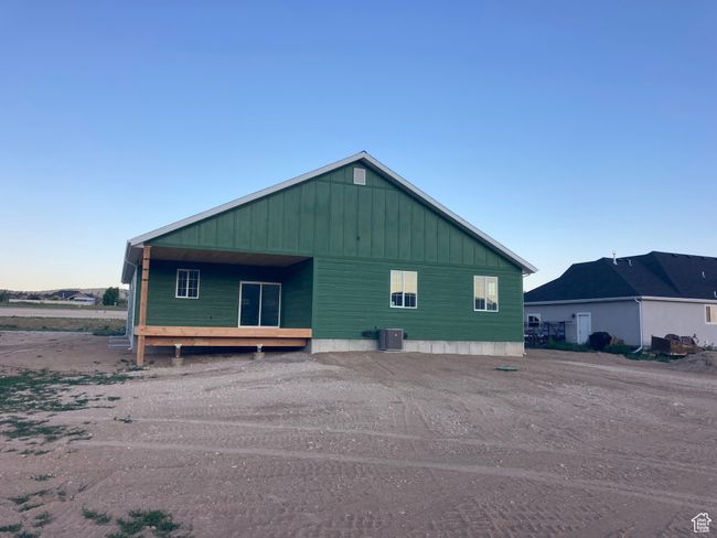 View of property exterior featuring a cooling unit and board and batten siding | Image 8