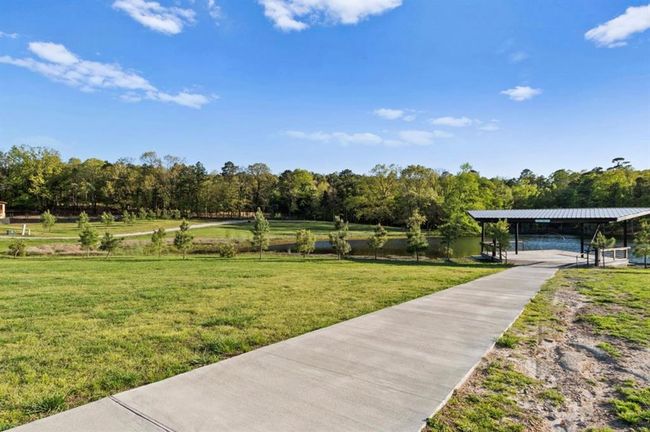 Surrounding community with a lawn and concrete driveway | Image 25