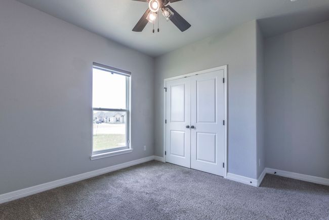 Unfurnished bedroom featuring carpet, a ceiling fan, and a closet | Image 21