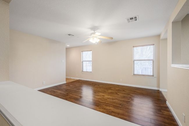 Spare room with ceiling fan and wood finished floors | Image 11