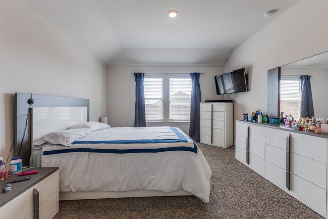 Carpeted bedroom with multiple windows and vaulted ceiling | Image 12