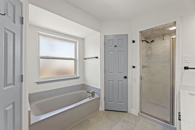 Full bath featuring wood finished floors, a sink, and a shower stall | Image 32