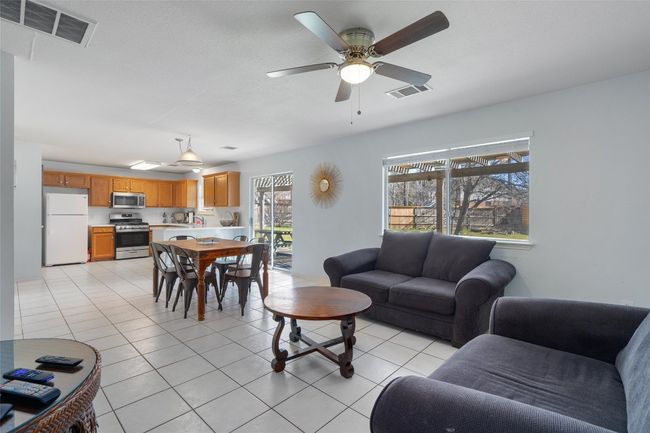 Living area with visible vents, ceiling fan, and light tile patterned flooring | Image 10