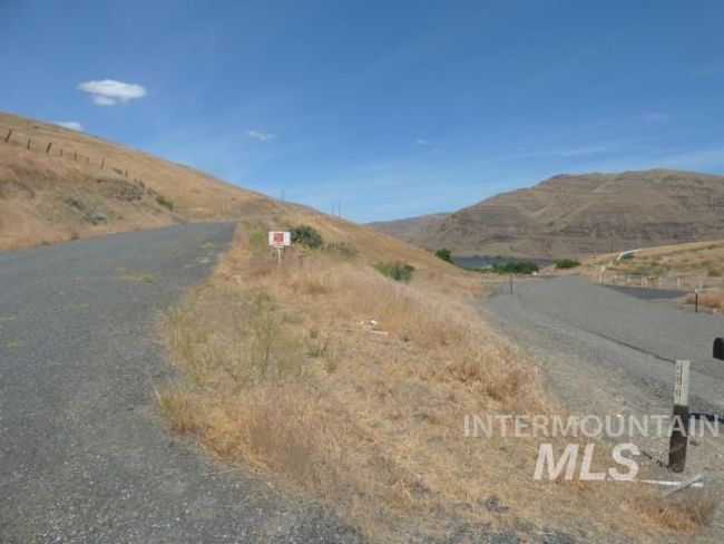 View of asphalt street with a mountain view and a view of rural / pastoral area | Image 42