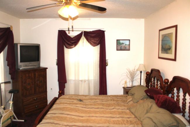 Bedroom featuring a ceiling fan | Image 14
