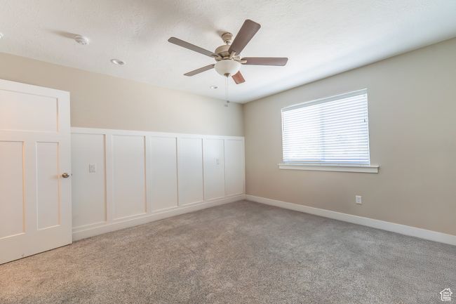 Carpeted empty room featuring a ceiling fan | Image 7
