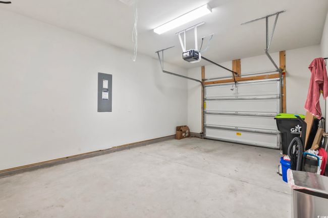 Garage with a garage door opener and electric panel | Image 8