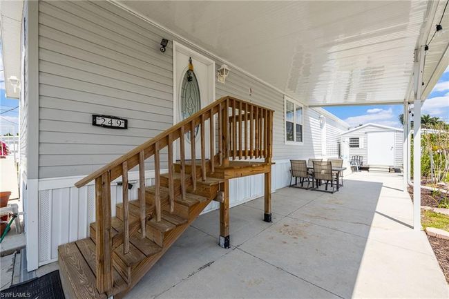 View of patio with outdoor dining area, an outbuilding, and a storage shed | Image 6