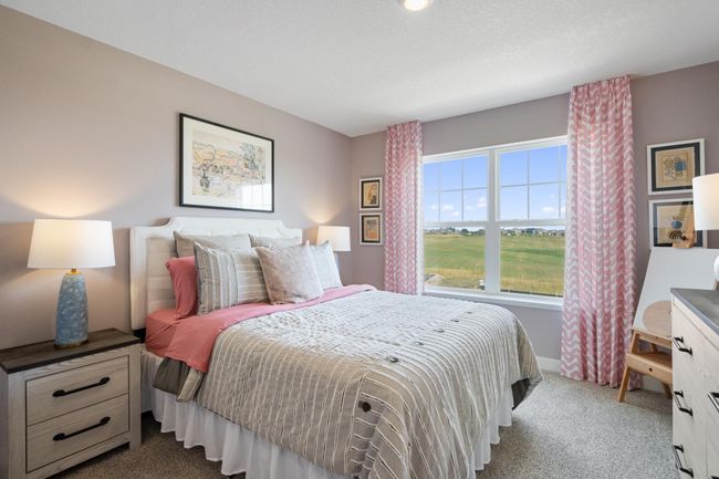 Each of the spacious secondary bedrooms feature well thought out window locations and a walk-in closet. Model photo. Options and colors will vary. | Image 26