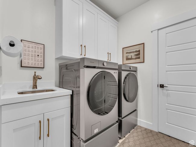 Laundry room featuring washer and clothes dryer and cabinet space | Image 27