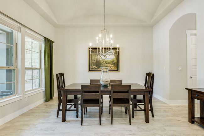 Formal dining area with curved ceilings & chandelier | Image 8