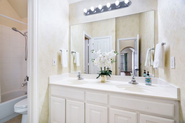 Full bathroom with double vanities, and bathtub / shower combination | Image 17