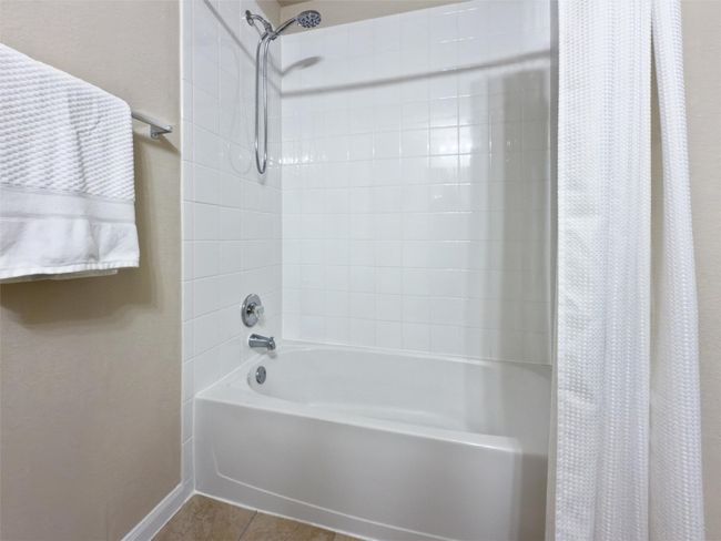 Enjoy a large soaking tub in the secondary bathroom. | Image 23