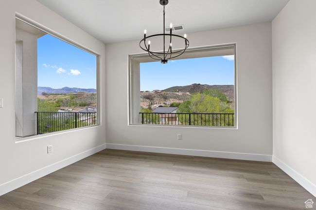 Unfurnished dining area with plenty of natural light, a mountain view, and an inviting chandelier | Image 7