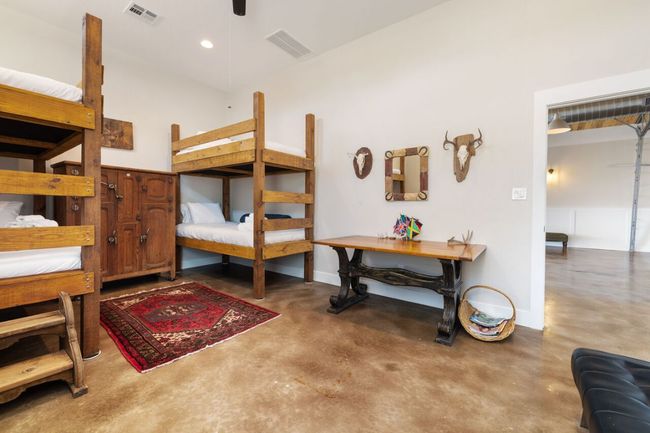 Bedroom with finished concrete floors and baseboards | Image 9
