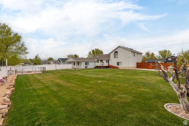 View of yard with a fenced backyard and a wooden deck | Image 50