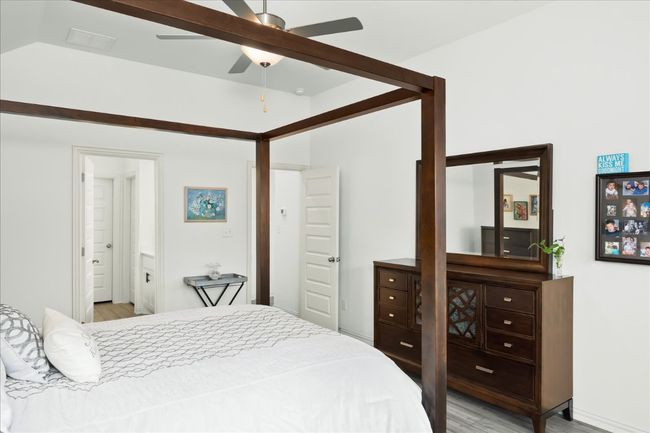 Bedroom with connected bathroom and light wood-type flooring | Image 23