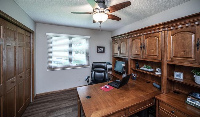 Second bedroom on upper level has ceiling fan with lights & windows to back. | Image 22